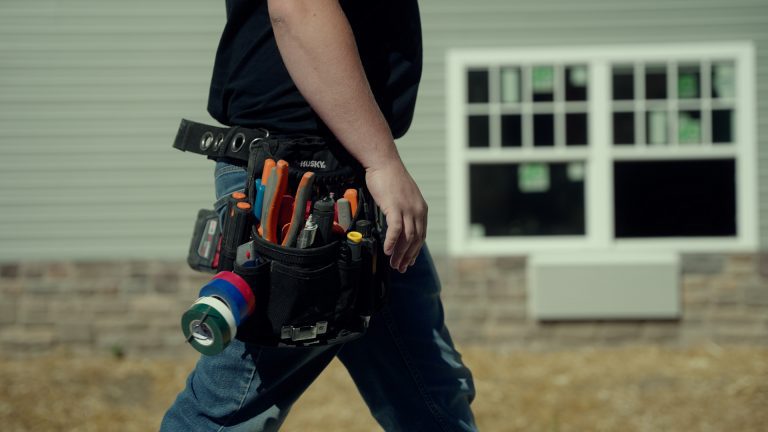 A man touching his toolbelt