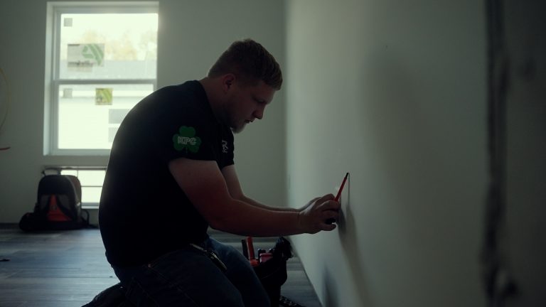 A man installing an outlet in the wall