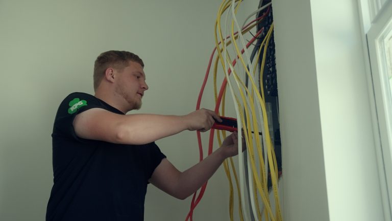 A man checking the voltage of a electrical line